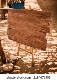 Wooden Sign Board On Sandy Floor