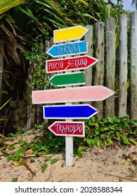 Wooden sign indicating tourist cities in southern Bahia, Porto Seguro, Caraiva and Arraial d'ajuda