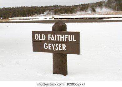 Wooden Sign For Old Faithful Geyser In Yellowstone National Park, Wyoming In Winter.