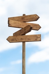 Wooden Sign Post Isolated On Blue Sky With White Clouds. Direction Concept. Mock Up, Template