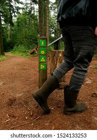 Wooden Sign Post Mile Marker On A Hiking Jogging Trail In A Forest Nature