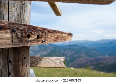 Wooden Sign Post At Summit Of Mountain In The Alps Showing The Direction Of Hiking Trails