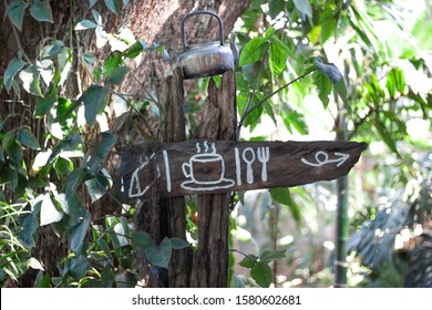 Wooden Sign For Restuarant With Kettle On Top.