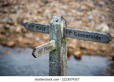 Wooden sign showing the direction to Kled, Muker and Gunnerside at the river swale in the Swaledale in Yorkshire, UK. - Shutterstock ID 2223079357