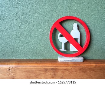 Wooden signage alcohol drink disallowed  area painted red and white color, put on wooden wall border with green rough stucco wall background. - Shutterstock ID 1625778115