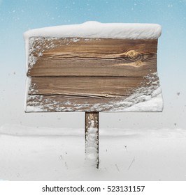 Wooden signpost with snow on it and snowfall on background - Powered by Shutterstock