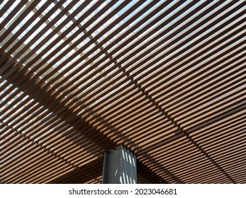 Wooden slats roof, architecture construction with sunlight streaming through and making beautiful shadow line.