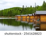 Wooden small cottages for camping on the shore of a forest lake, Quebec, Canada