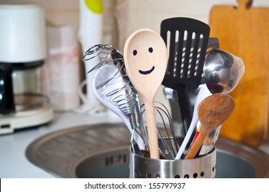 The wooden smiling spoon and kitchen accessories in the kitchen