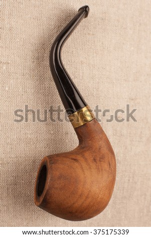 Wooden Smoking pipe on a linen beige background