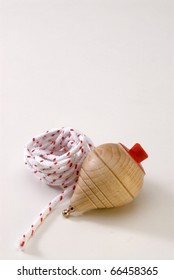 Wooden Spinning Top And Cord In White Background