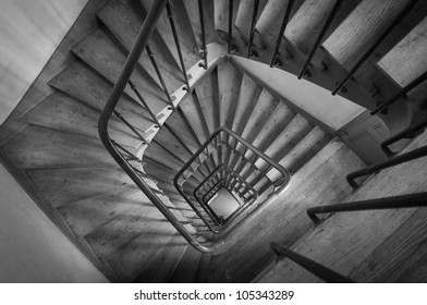 Wooden spiral staircase in an old parisian building (overlook)
