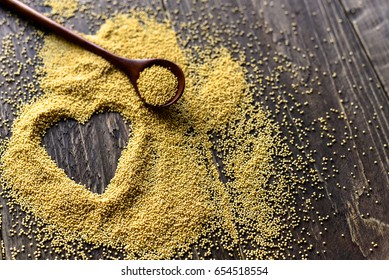 Wooden spoon with amaranth seeds and drawn heart with seeds - Shutterstock ID 654518554