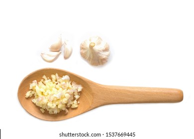 Wooden spoon of Chopped garlic with white background.
Minced garlic in Wooden spoon.
top view.
