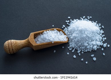 wooden spoon with coarse salt on a black background.  - Shutterstock ID 1911941614