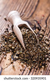 Wooden Spoon With Crushed Peppercorns (detailed Close-up Shot)