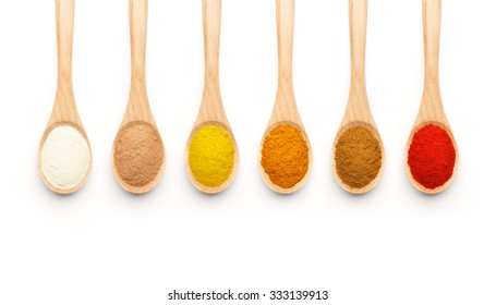 Wooden Spoon filled with colorful spices on white background - Powered by Shutterstock