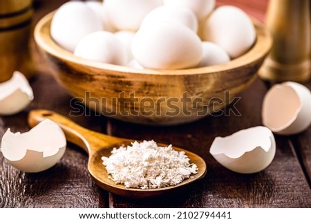 wooden spoon with ground eggshells, used white eggshell prepared for use as fertilizer, leftover food