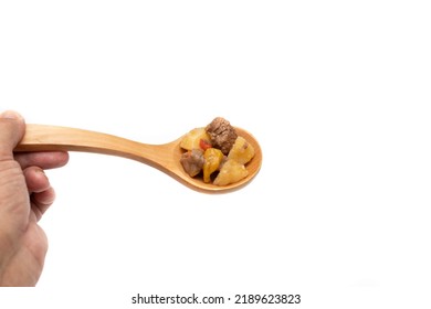 Wooden Spoon With Hungarian Goulash, Beef, Pork Stew With Potatoes, Isolated On White Background. It Is A Spicy Dish, Made Mainly With Meat, Onions, Peppers And Paprika.