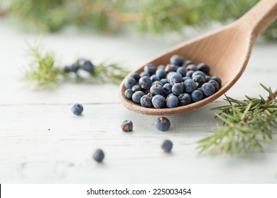 Wooden spoon with juniper berries