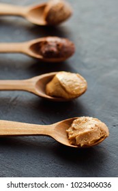 Wooden Spoon With Peanut Butter On A Dark Background