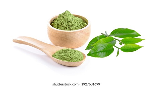 Wooden spoon with powdered matcha green tea in bowl and leaf tea