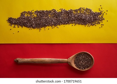 Wooden Spoon With Scattered Chia Seeds Red And Yellow Background