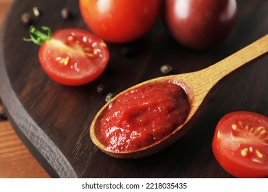 Wooden Spoon Of Sweaty Tomato Sauce Close Up On Textured Background