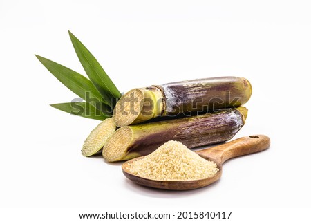 wooden spoon with unrefined raw cane sugar, demerara sugar, with sugar cane, isolated white background with copyspace
