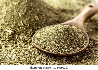 wooden spoon with yerba mate on background with herb
