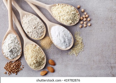 Wooden spoons of various gluten free flour (almond flour, amaranth seeds flour, buckwheat flour, rice flour, chick peas flour) from top view - Shutterstock ID 419782876