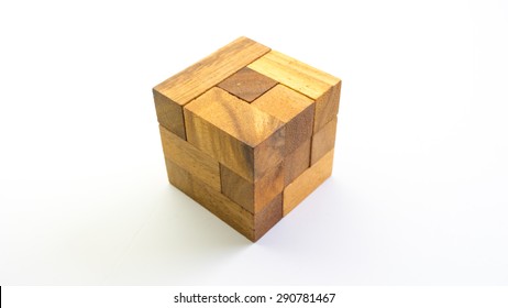 Wooden square block cube puzzle. Isolated on white background. Concept of complex and smart logical thinking. Slightly defocused and close up shot. Copy space.