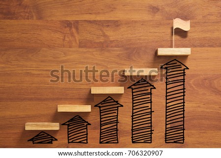 wooden staircase to reach goal and winning flag with increase graph and arrow, successful