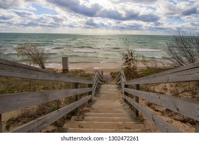 Wooden Stairs To Beach. Long wooden staircase leads to a sunny sandy beach on the Michigan coast of Lake Michigan.