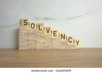 Wooden stairs down with word solvency. Creditworthiness, banking conditions, credit funds concept - Shutterstock ID 2162493495
