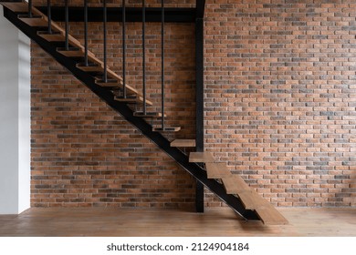 Wooden stairs in modern loft styled room. Modern building with brick wall inside. Modern office for rent. Industrial style room. Multistorey apartment - Powered by Shutterstock