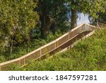 Wooden stairway up to an ancient earthen native American temple mound at Lake Jackson Mounds Archaeological State Park in Tallahassee, Florida, USA