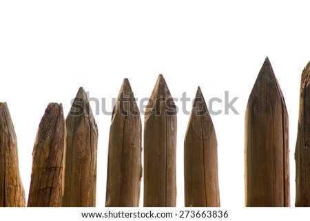 wooden stakes or wall made from wooden logs, isolated on white.