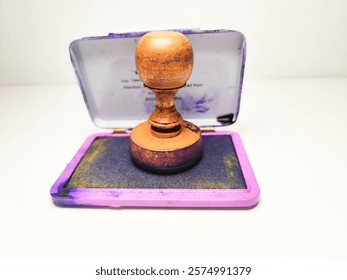 A wooden stamp is a tool whose surface is engraved with writing, images, or a combination of both. It is typically used with ink to produce an impression on documents or files.