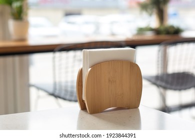 Wooden Stand For Paper Napkins On A Table In A Cafe. Restaurant Service.