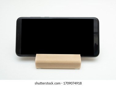 Wooden stand for smartphone isolated