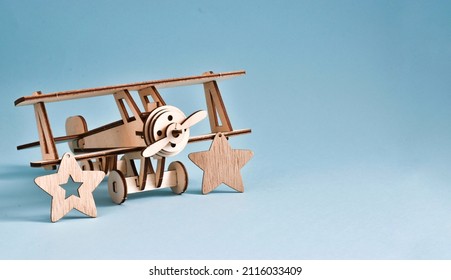 The wooden stars is the symbol of the army. The plane with wood stars on blue background. February 23, 9 may concept. Copy space. Greeting card for holiday - Shutterstock ID 2116033409