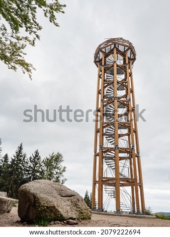 Wooden and steel  lookout tower called Svetly Vrch. Hiking at Albrechtice in Jizerske mountains, Czechia. Original watch tower overlooks summer cloudy countryside, active life