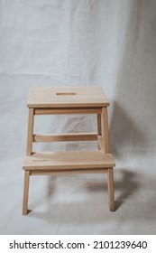 A Wooden Step Stool Ion White Background