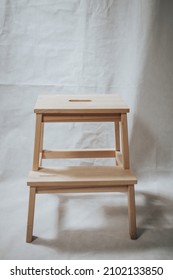 A Wooden Step Stool Ion White Background