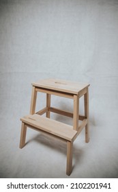 A Wooden Step Stool Ion White Background