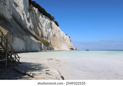 Wooden steps on the beach and the white chalk cliff eroded by the sea and wind in southern Denmark at a location called MONS KLINT - Powered by Shutterstock