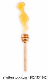 Wooden stick dipper with pool of honey isolated on white background