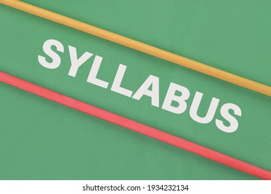 Wooden sticks over green background written with SYLLABUS.