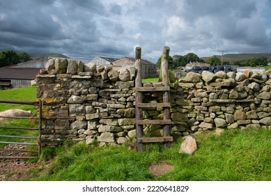 Wooden stile on a hiking path in the Yorkshire Dales, England, UK. - Shutterstock ID 2220641829